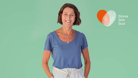 man-observing-stoma-pouch-on-his-abdomen-thinking-about-body-image-concerns-with-a-stoma